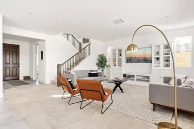 a living room with a couch and a table at Luxury Mountain View Home w/ large backyard in Santa Clarita