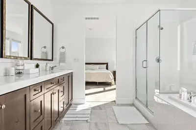 a bathroom with a sink and a shower and a bed at Scenic Mountain View Home with Spacious Yard in Santa Clarita