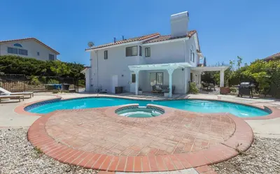 a swimming pool in front of a house at Goode.Homes Hilltop Home w. private pool/spa in Newhall