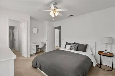 a white bedroom with a bed and a ceiling fan at GOODE.HOMES | Luxury Home w/ pool & lush gardens in Santa Clarita