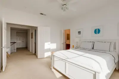 a white bedroom with a white bed and a table at GOODE.HOMES | Luxury Home w/ pool & lush gardens in Santa Clarita