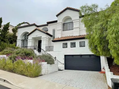 a large white house with a garage at Large 6-bedroom house w/jacuzzi in Monterey Park