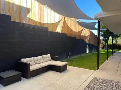 a couch sitting on a patio next to a wall at Large 6-bedroom house w/jacuzzi in Monterey Park