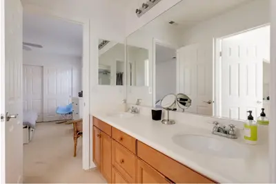 a bathroom with two sinks and a large mirror at Mountain View Home with Pool & Fenced-In Yard in Santa Clarita