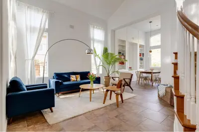 a living room with a blue couch and a table at Mountain View Home with Pool & Fenced-In Yard in Santa Clarita