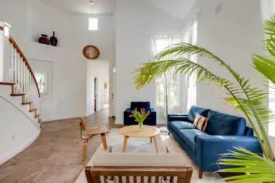 a living room with a blue couch and a table at Mountain View Home with Pool & Fenced-In Yard in Santa Clarita