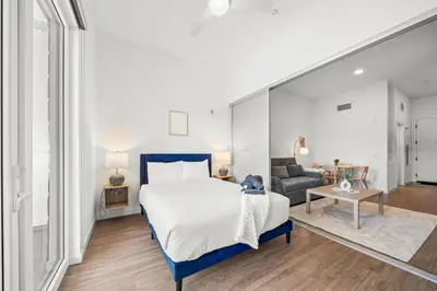 a bedroom with a large bed and a couch at Modern Getaway Heart of Long Beach in Long Beach