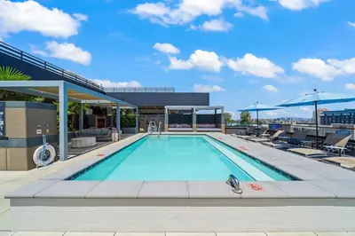 a swimming pool on the roof of a building at Modern Getaway Heart of Long Beach in Long Beach