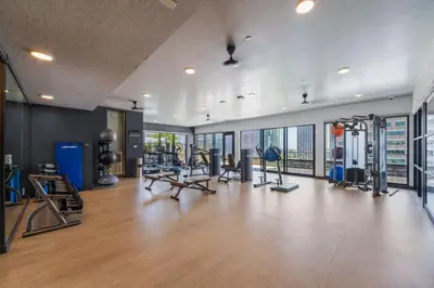 a gym with treadmills and exercise equipment in a building at Modern Getaway Heart of Long Beach in Long Beach