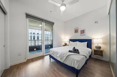 a bedroom with a large bed and a window at Stylish City Escape Walk to Shops Dine & Explore in Long Beach