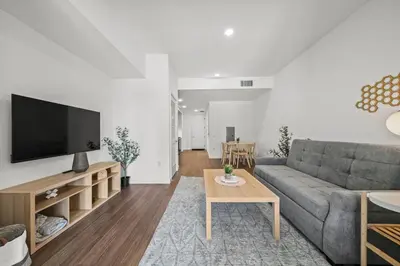 a living room with a couch and a tv at Stylish City Escape Walk to Shops Dine & Explore in Long Beach