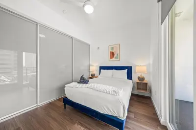 a bedroom with a bed and a large window at Chic Downtown Stay Walk to Beach in Long Beach