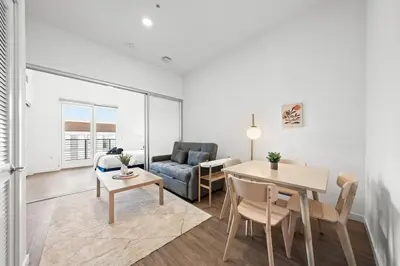 a living room with a table and a couch at Top-Floor Gem & Heated Pool Walk to Attractions in Long Beach
