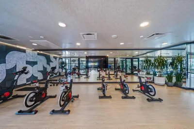a gym with a bunch of exercise bikes in a building at Top-Floor Gem & Heated Pool Walk to Attractions in Long Beach
