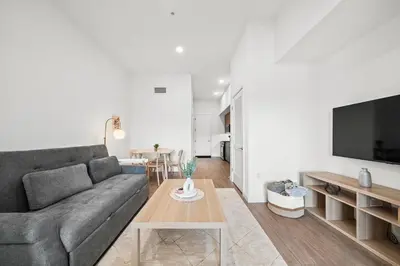 a living room with a couch and a table at Top-Floor Gem & Heated Pool Walk to Attractions in Long Beach