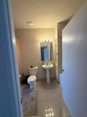 a bathroom with a toilet and a sink at Aqua Towers in Long Beach