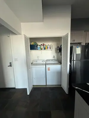 a small kitchen with white appliances and a refrigerator at Aqua Towers in Long Beach
