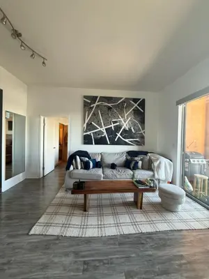 a living room with a couch and a painting on the wall at Aqua Towers in Long Beach