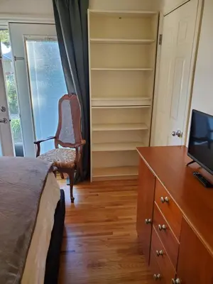 a bedroom with a desk and a chair and a television at Hidden Gem In Plain Sight in Van Nuys Airport