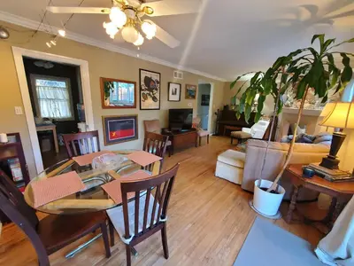 a living room with a table and a dining room at Hidden Gem In Plain Sight in Van Nuys Airport