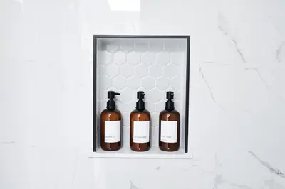 four bottles of wine in a shelf on a wall at Family Friendly Southwest Bakersfield Retreat with Jacuzzi and Fenced Yard in Bakersfield