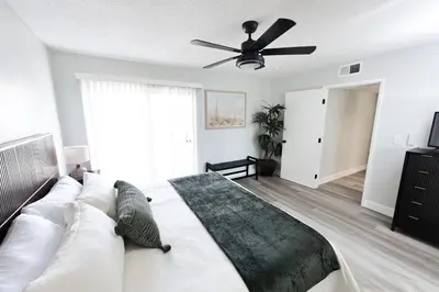 a bedroom with a bed and a ceiling fan at Family Friendly Southwest Bakersfield Retreat with Jacuzzi and Fenced Yard in Bakersfield
