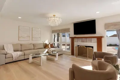 a living room with a couch and a fireplace at Dream Dip - Heater Pool and Spa - Clost to Disney in Placentia