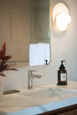 a bathroom sink with a bottle of soap on it at University Hill Home With City Views, Hot Tub and 3 Parking Spots in Los Angeles