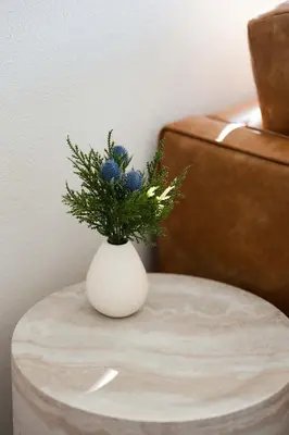 a white vase with blue flowers on a table at University Hill Home With City Views, Hot Tub and 3 Parking Spots in Los Angeles