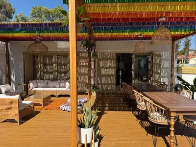 a patio with a table and chairs on a deck at WeHo Pool Retreat - Holiday Ready in Los Angeles