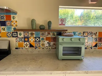 a green stove in a kitchen with tiles at WeHo Pool Retreat - Holiday Ready in Los Angeles