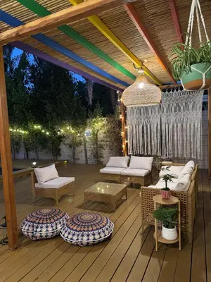 an outdoor patio with couches and tables and lights at WeHo Pool Retreat - Holiday Ready in Los Angeles