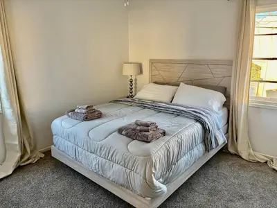 a bedroom with a bed with towels on it at Unique apartment in Los Angeles