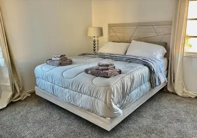 a bedroom with a bed with towels on it at Unique apartment in Los Angeles