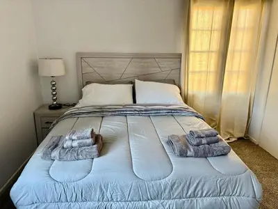 a bedroom with a bed with towels on it at Unique apartment in Los Angeles