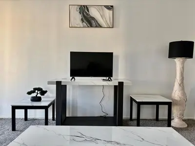 a desk with a television and a lamp in a room at Unique apartment in Los Angeles