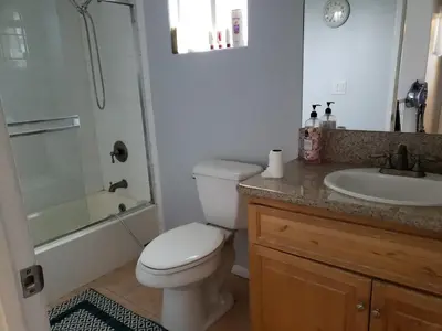 a bathroom with a toilet and a sink and a shower at Spacious home near LAX in Hawthorne