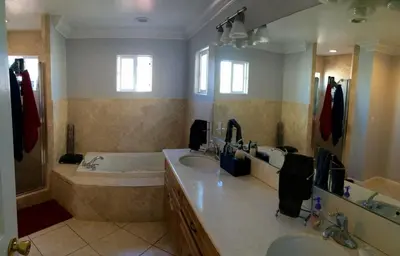 a bathroom with a tub and two sinks and a bath tub at Spacious home near LAX in Hawthorne