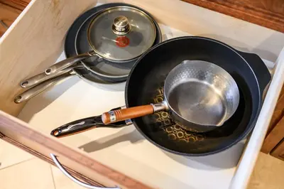 a frying pan with a utensil in a drawer at Airy Large Backyard Oasis Perfect Family Getaway in Tustin