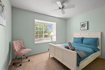 a bedroom with a bed and a chair and a window at Airy Large Backyard Oasis Perfect Family Getaway in Tustin