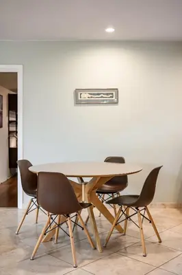 a table and chairs in a room with a wall at Airy Large Backyard Oasis Perfect Family Getaway in Tustin