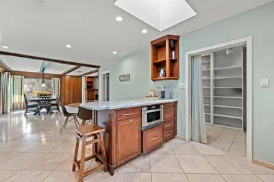 a kitchen with a counter and a dining room at Airy Large Backyard Oasis Perfect Family Getaway in Tustin