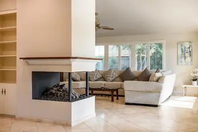 a living room with a fireplace and a couch at Airy Large Backyard Oasis Perfect Family Getaway in Tustin