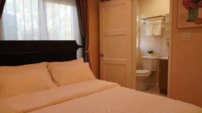 a bedroom with a bed with a window and a toilet at Entire house with 3 rooms in Alhambra