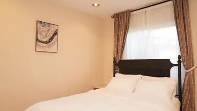 a bedroom with a bed with white sheets and a window at Entire house with 3 rooms in Alhambra