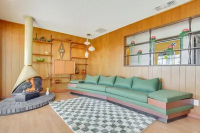 a living room with a couch and a fireplace at Stunning MCM Escape with Mtn Views in San Bernardino in San Bernardino