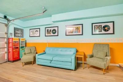 a living room with a blue couch and two chairs at Stunning MCM Escape with Mtn Views in San Bernardino in San Bernardino