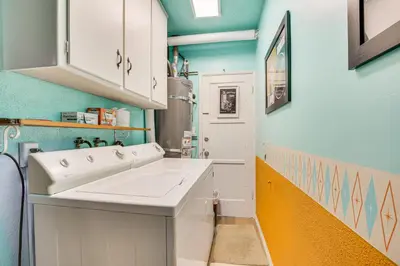 a kitchen with a white sink and blue walls at Stunning MCM Escape with Mtn Views in San Bernardino in San Bernardino