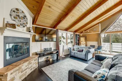 a living room with a couch and a fireplace at 2 Mi to Lake Arrowhead! Mtn-View Hideaway with Deck in Cedar Glen