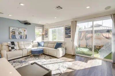 a living room with a couch and a large window at Home Theater System and Gazebo Los Angeles Getaway! in San Fernando